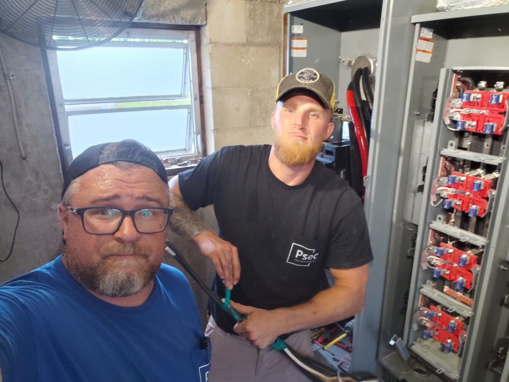 PSEC Team Wiring Meter Bank — Two Electricians Installing Breakers and Conductors