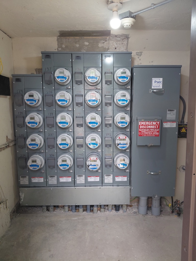 After — Completed 20-Position Meter Bank, Numbered Units, Emergency Disconnect, PSEC Label, Fully Energized — Install 1