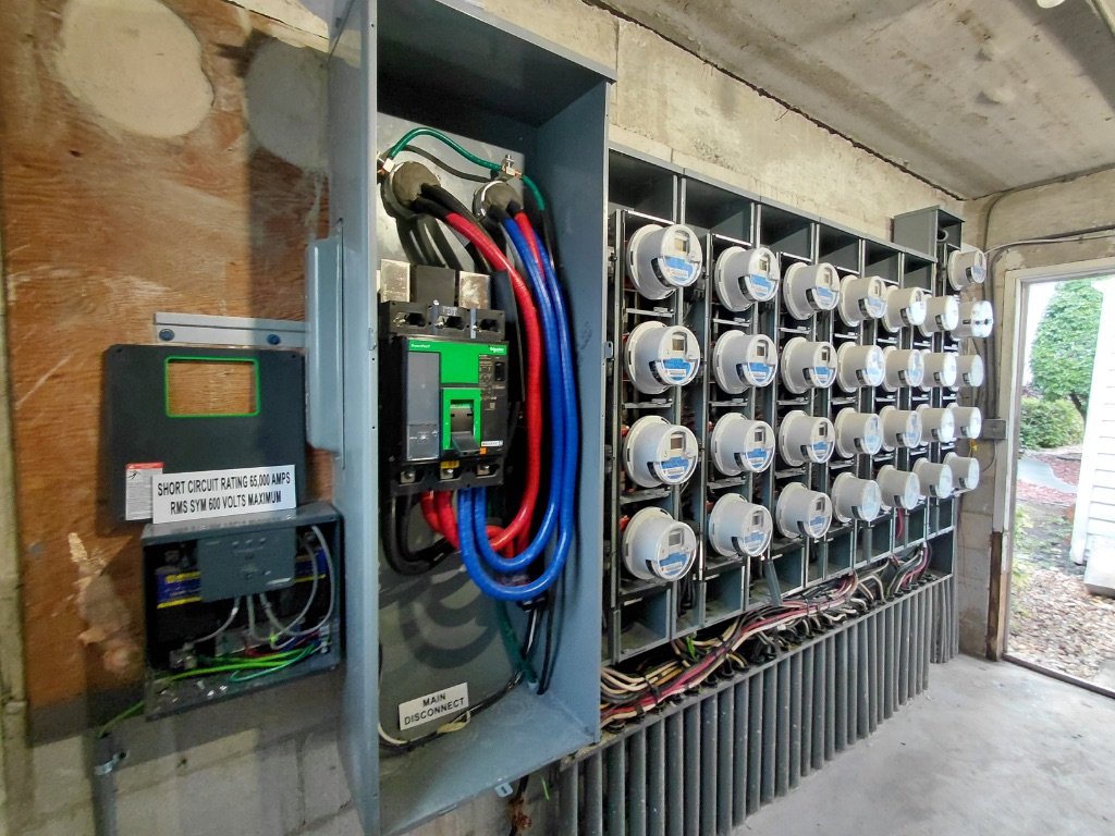 Meter Bank Internal View — Main Disconnect Installed, Meters Seated, Conductors Routed