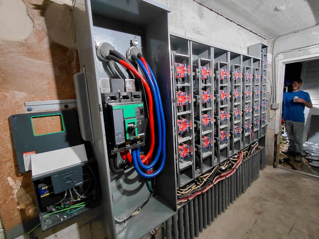 Meter Bank Nearing Completion — Breakers Loaded, Disconnect Installed, PSEC Technician On Site