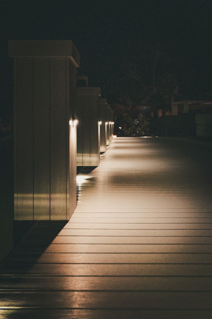 Warm White Piling Row Lights — Long Dock Perspective Shot at Night