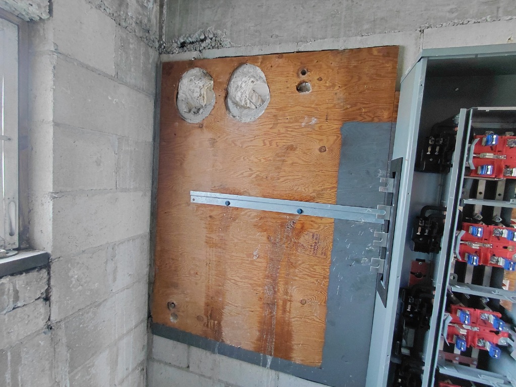 FPL Vault — Plywood Backboard Mounted, Conduit Core Holes Open Before Patching